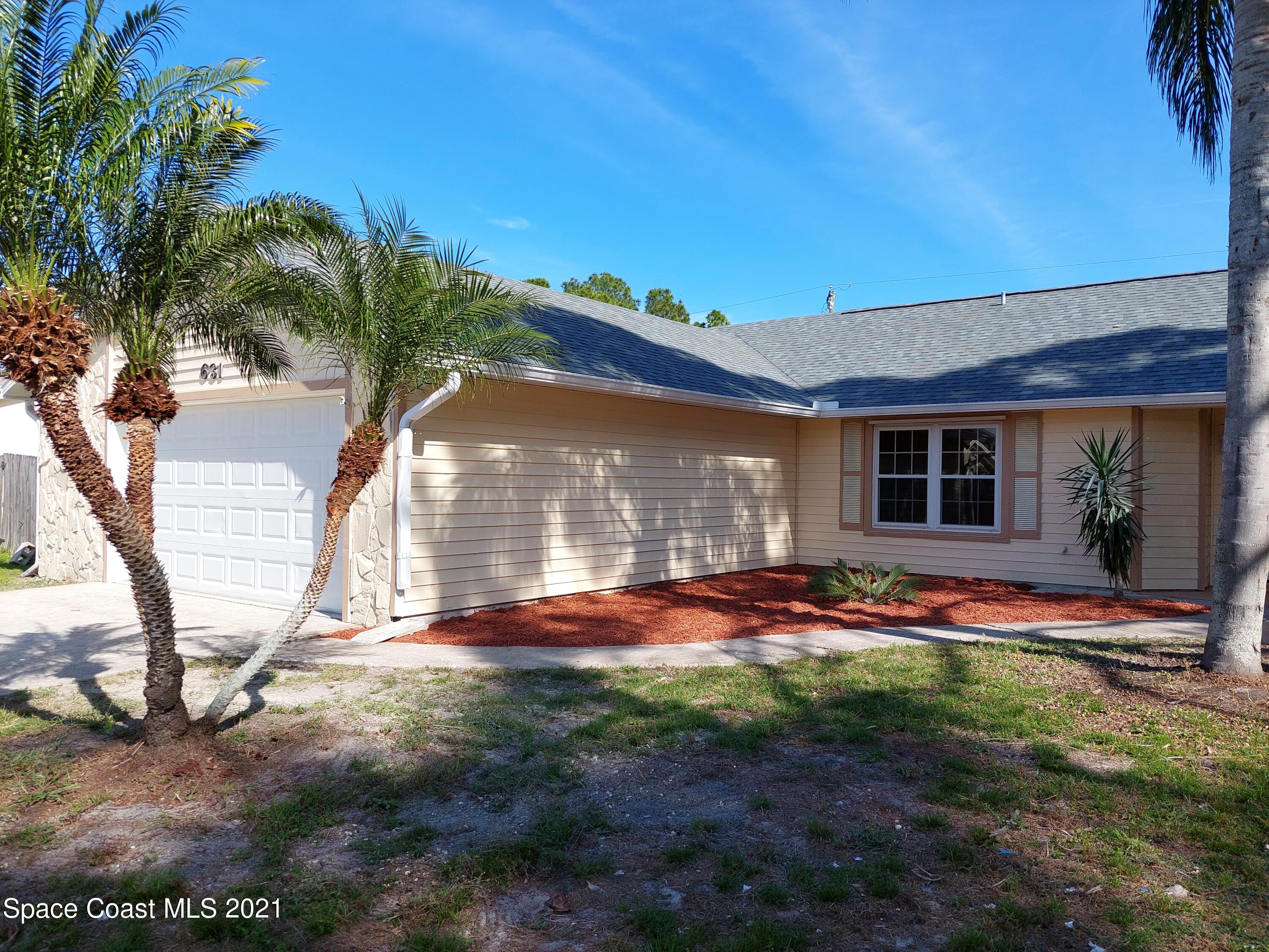 631 Furth Road Northwest Palm Bay, FL 32907 - Photo 5 of 42 a backyard of a house with table and chairs