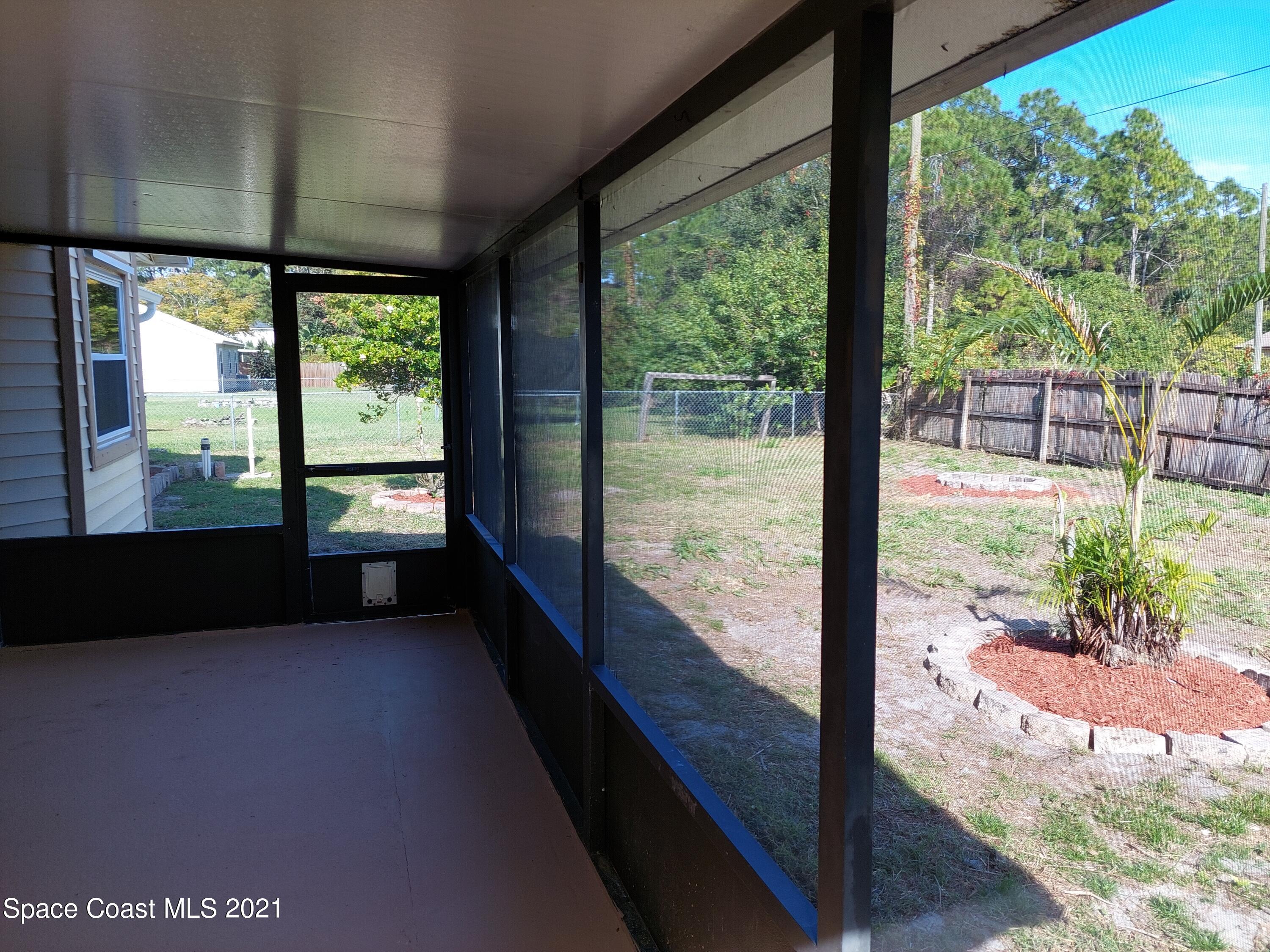 631 Furth Road Northwest Palm Bay, FL 32907 - Photo 42 of 42 a view of a floor to ceiling window and wooden floor