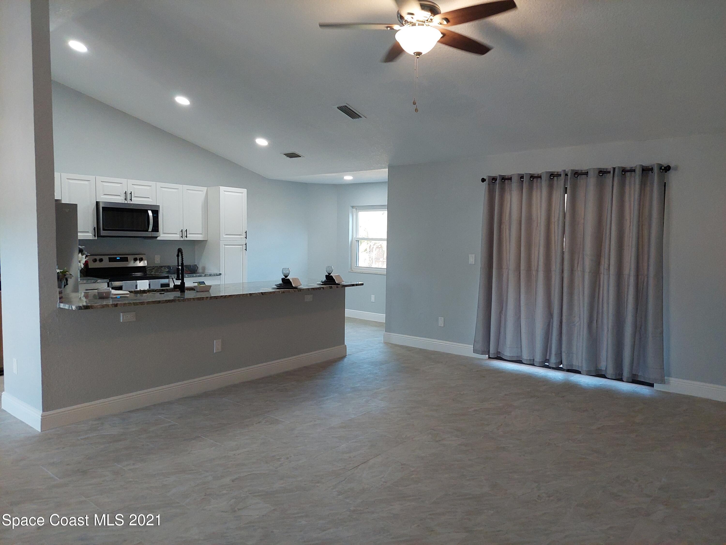 631 Furth Road Northwest Palm Bay, FL 32907 - Photo 9 of 42 a view of kitchen with microwave and cabinets