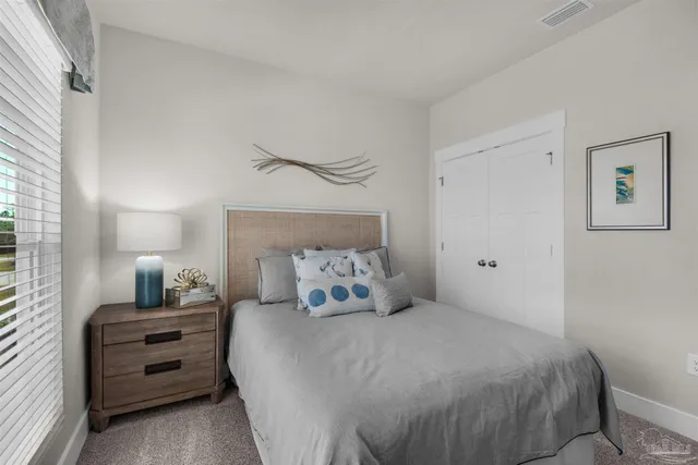 a bedroom with a bed and a night stand