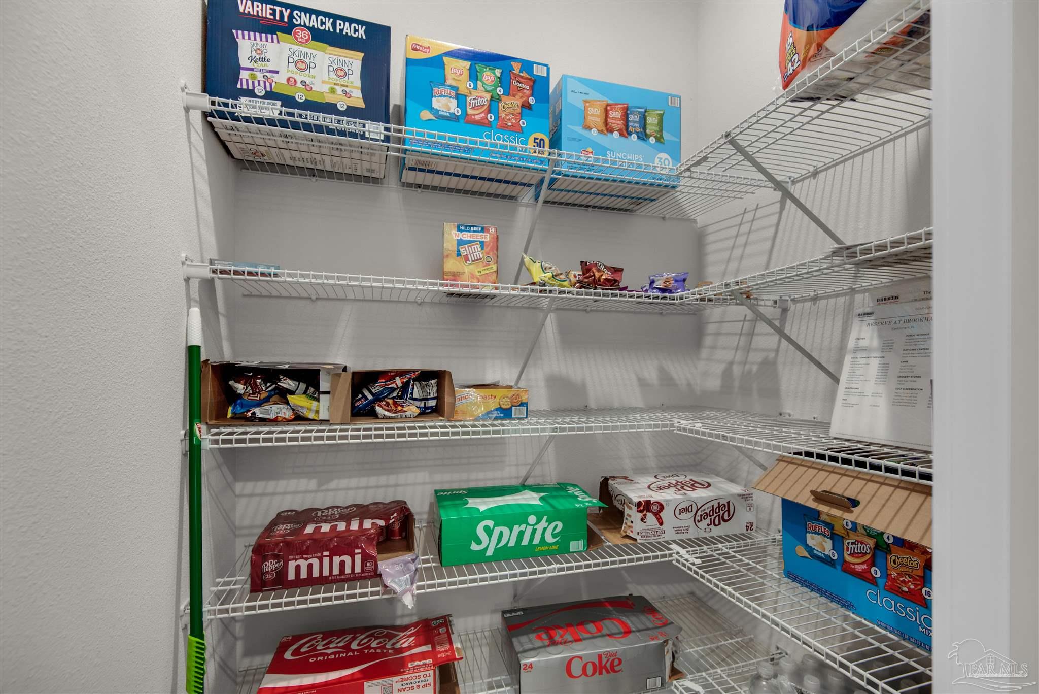 3468 Crossvine Road Cantonment, FL 32533 - Photo 28 of 45 a store room with lots of different colored cloths