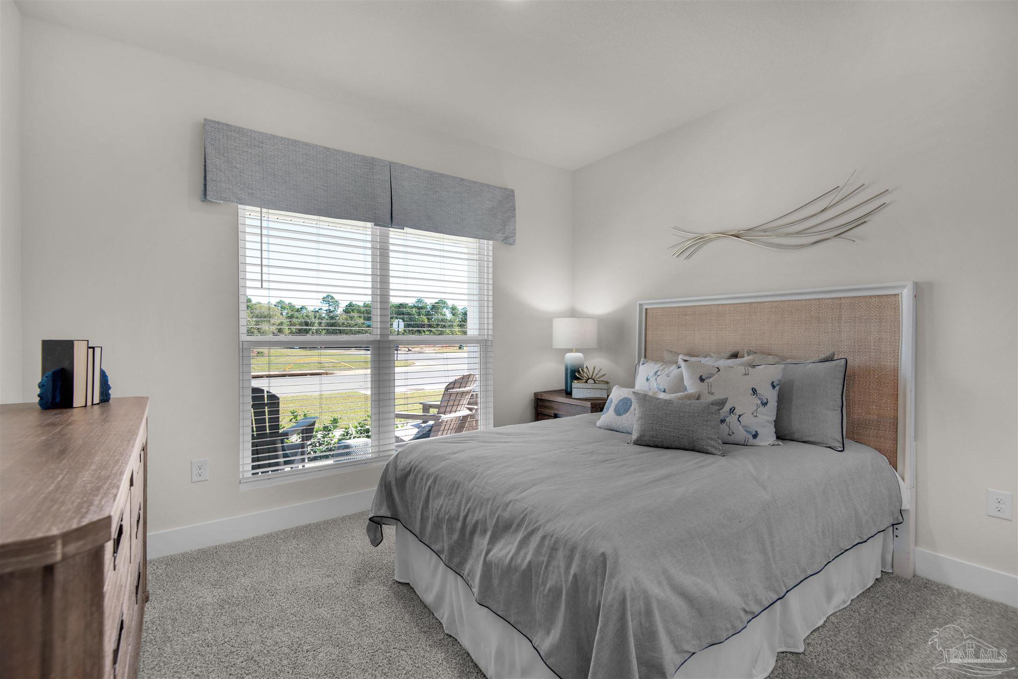 3468 Crossvine Road Cantonment, FL 32533 - Photo 10 of 45 a bedroom with a large bed and a large window