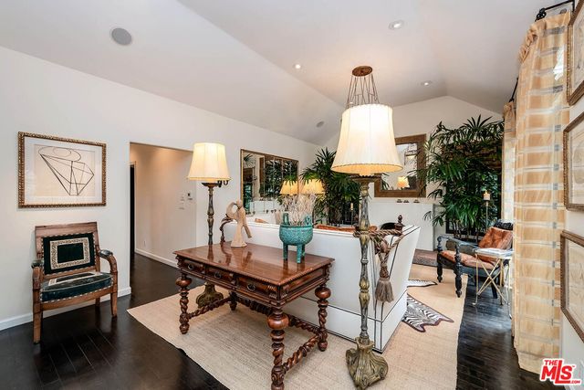 a living room with furniture a table and a chandelier