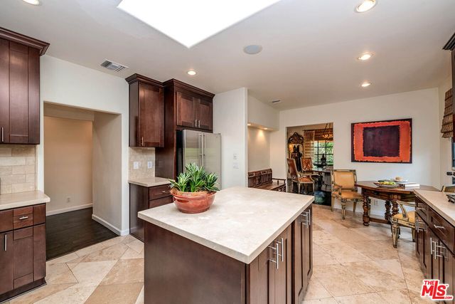 a kitchen with a table and chairs