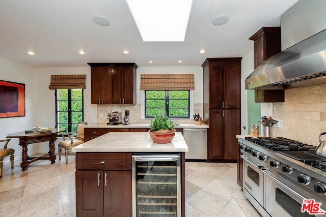 a kitchen with a stove a sink and a refrigerator