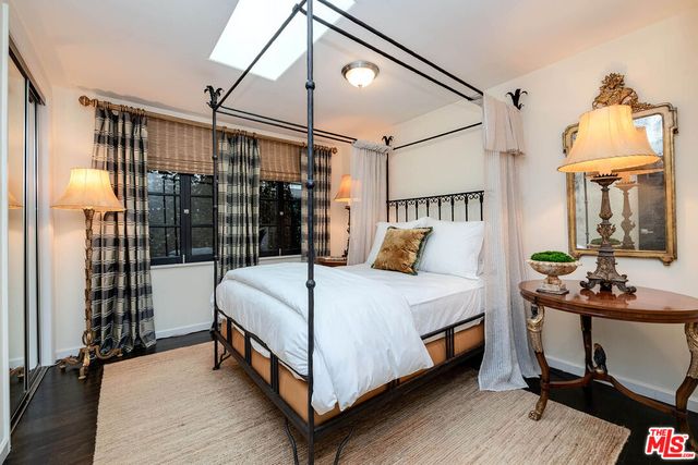 a bed room with a bed and a window