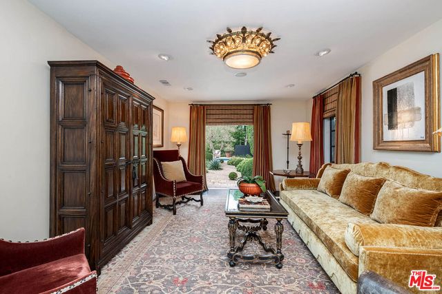 a living room with furniture fireplace and a large window