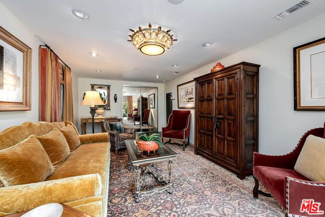 a living room with furniture a rug and a window