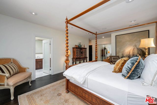 a bedroom with a large bed and a couch