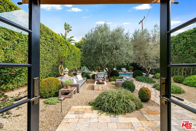a view of a backyard with sitting area and furniture