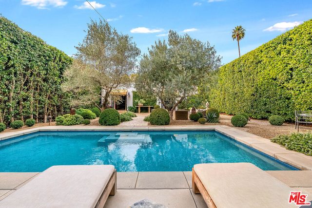 a view of a swimming pool with an outdoor seating