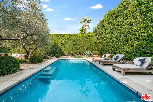 a view of back yard with swimming pool