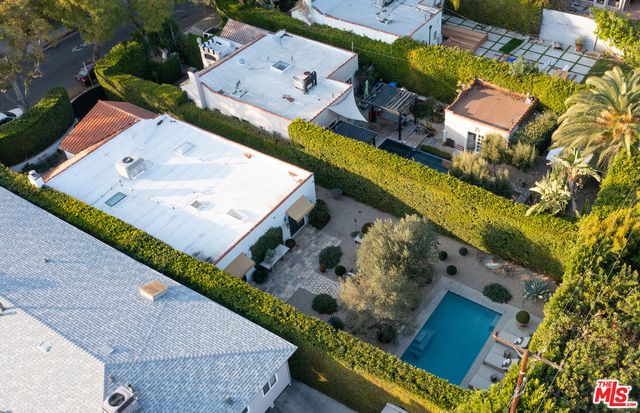 an aerial view of a house with a garden and chairs