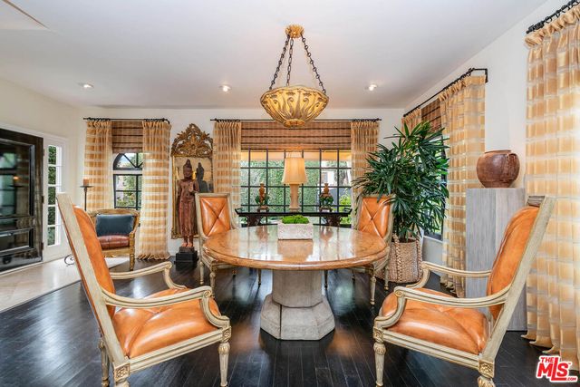 a view of a dining room with furniture wooden floor and chandelier