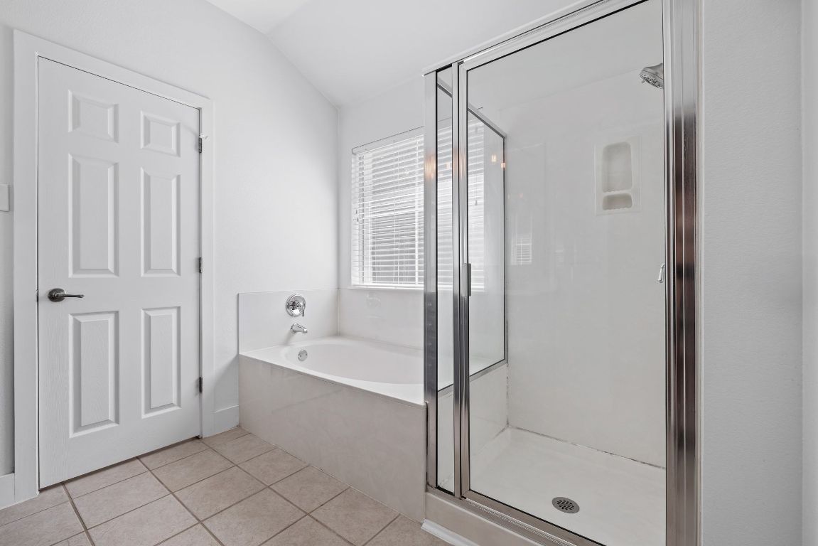 9324 Muskberry Cove Austin, TX 78717 - Photo 17 of 26 a bathroom with a bathtub and a shower