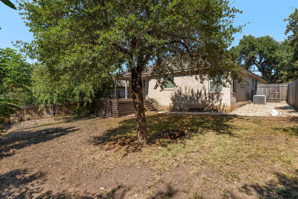 9324 Muskberry Cove Austin, TX 78717 - Photo 25 of 26 a backyard of a house with lots of green space