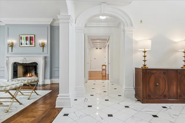 a living room with furniture a fireplace and a chandelier