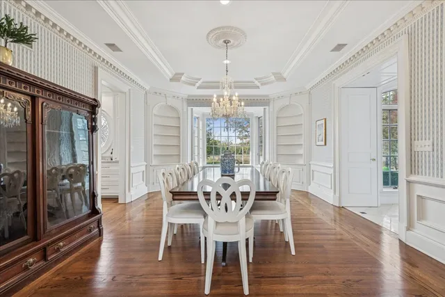 a living room with furniture large window and wooden floor
