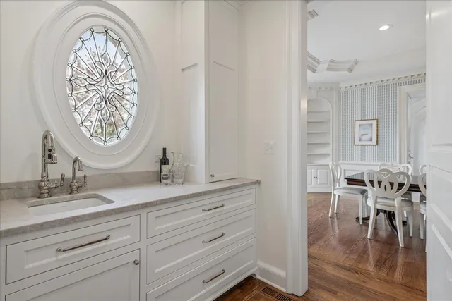 a living room with furniture a window and a chandelier