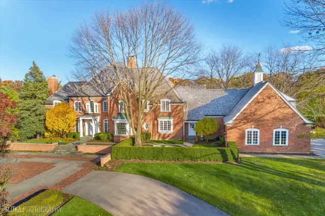 an aerial view of a house with a yard basket ball court and outdoor seating