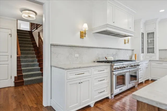 a kitchen with stainless steel appliances granite countertop a sink and a window