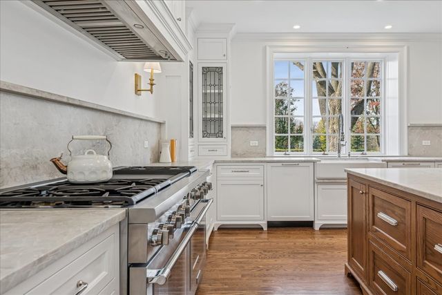 a kitchen with stainless steel appliances granite countertop a sink and a window