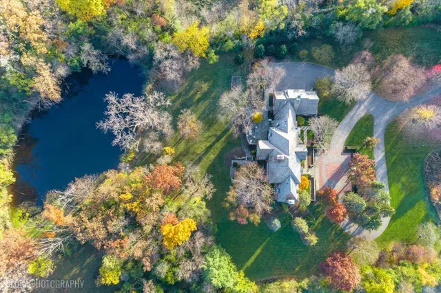 a living room with fireplace furniture and a large window
