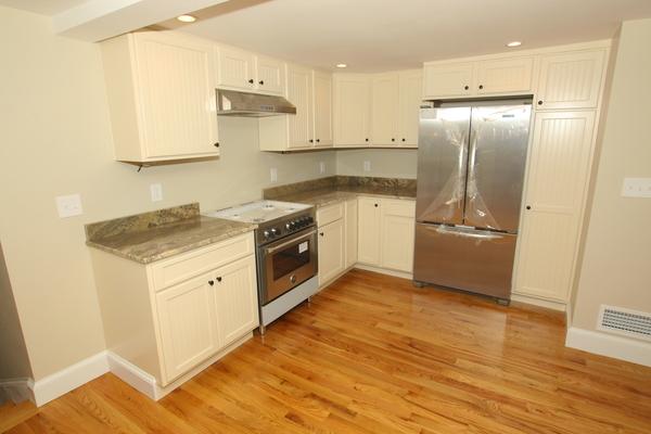64 Eastern Point Road, Unit 1 Gloucester, MA 01930 - Photo 8 of 30 a kitchen with stainless steel appliances granite countertop a sink stove and refrigerator