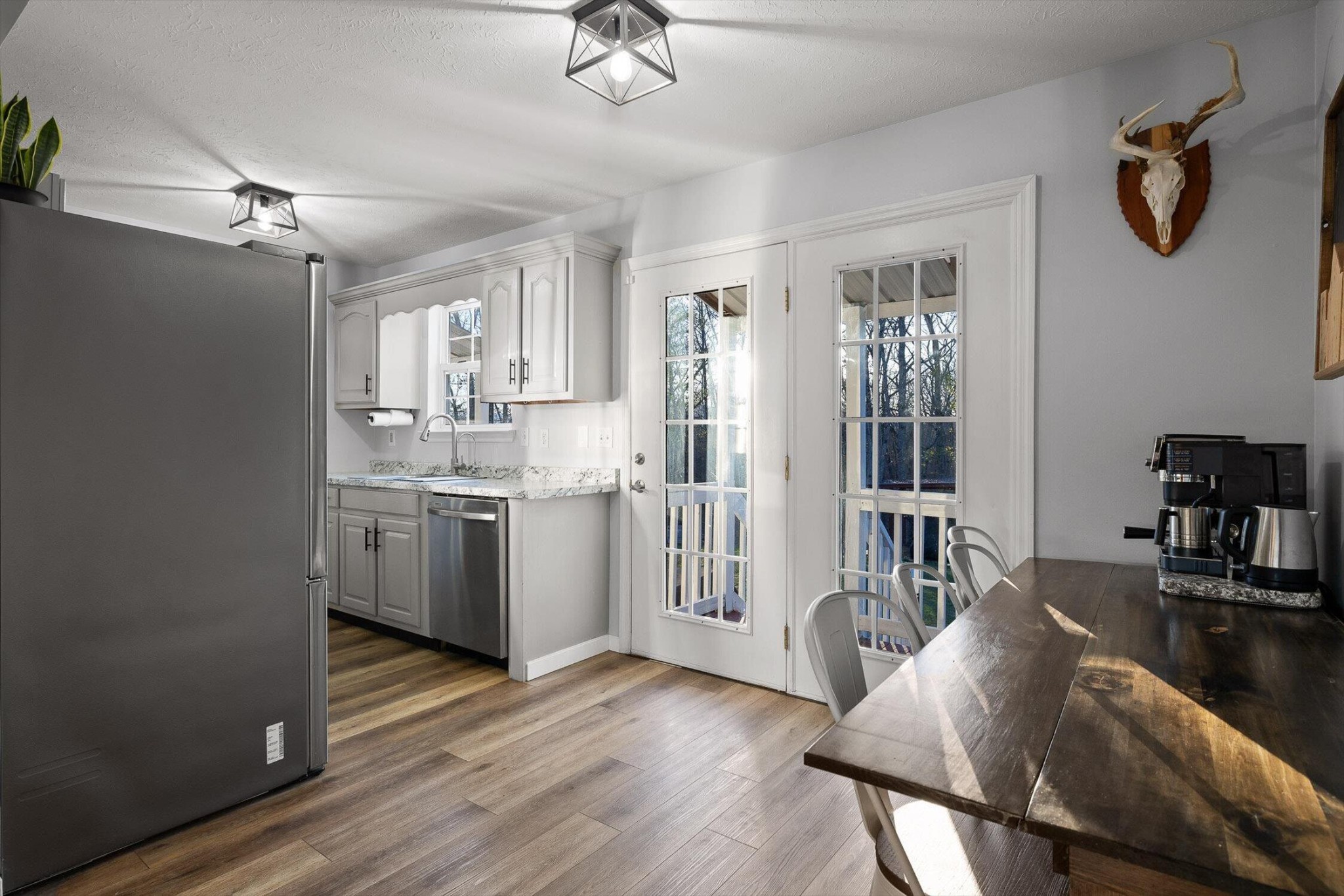 1068 Rogers Road Chickamauga, GA 30707 - Photo 12 of 68 a kitchen with a table chairs refrigerator and cabinets