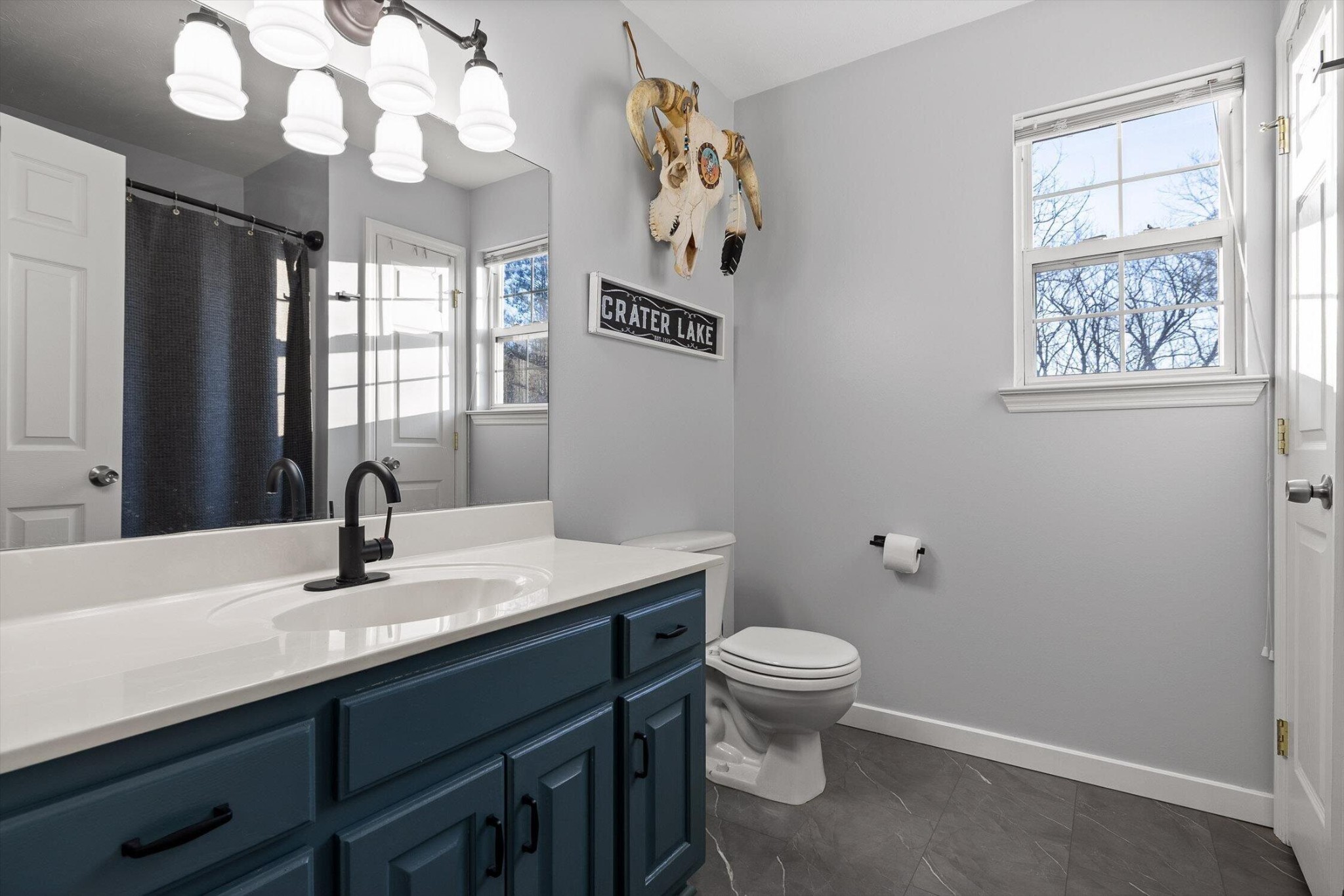 1068 Rogers Road Chickamauga, GA 30707 - Photo 25 of 68 a bathroom with a sink a toilet and a mirror