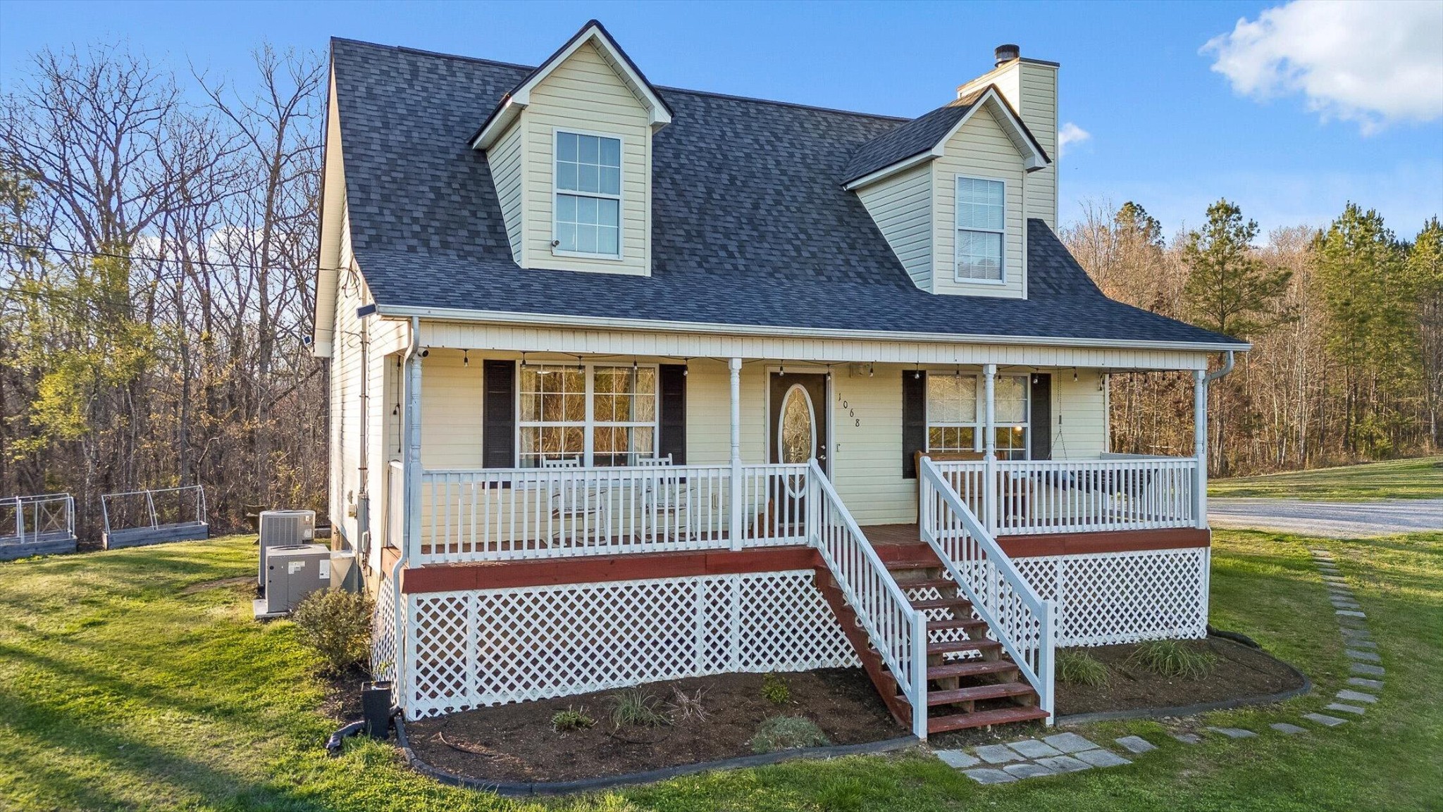 1068 Rogers Road Chickamauga, GA 30707 - Photo 61 of 68 a front view of a house with a yard glass top table and chairs