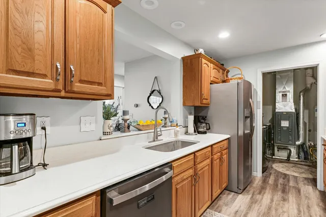a kitchen with refrigerator cabinets and a sink