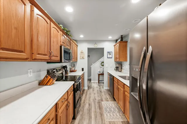 a kitchen with stainless steel appliances a refrigerator sink and cabinets