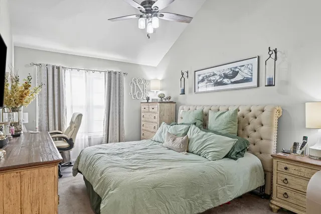 a bedroom with a bed a couch and dresser