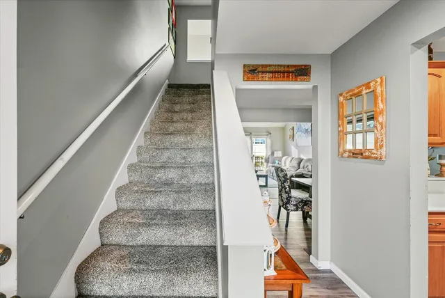 a view of entryway and hall with a living room