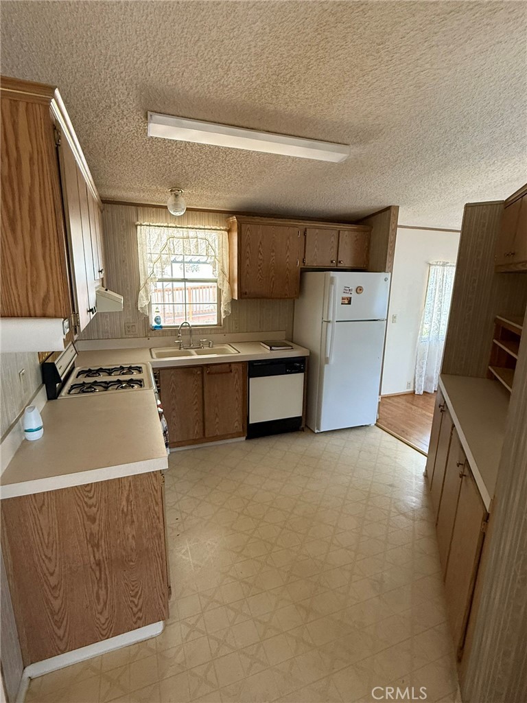 2658 Brougham Drive Oroville, CA 95966 - Photo 5 of 23 a kitchen with a sink a stove and a refrigerator
