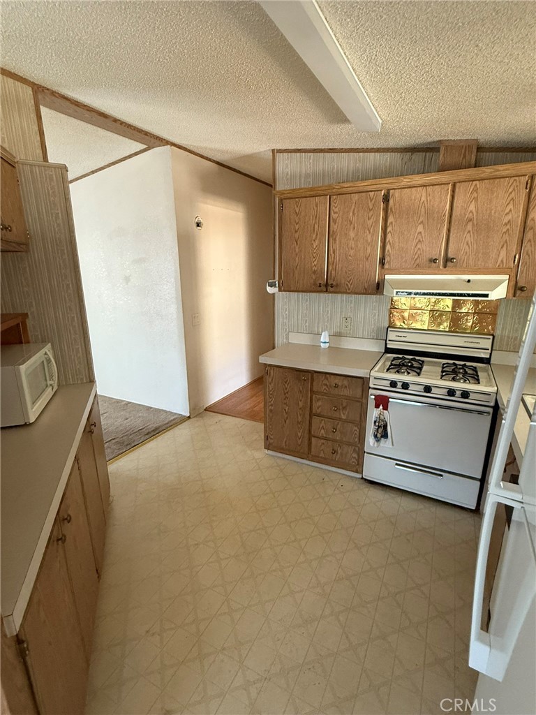 2658 Brougham Drive Oroville, CA 95966 - Photo 6 of 23 a kitchen with a stove and a refrigerator