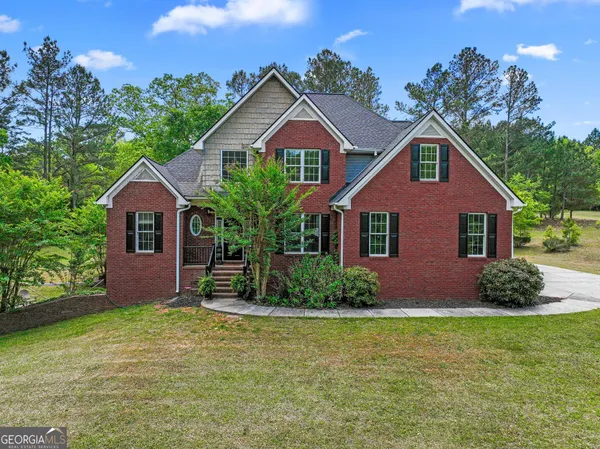 a front view of a house with a garden