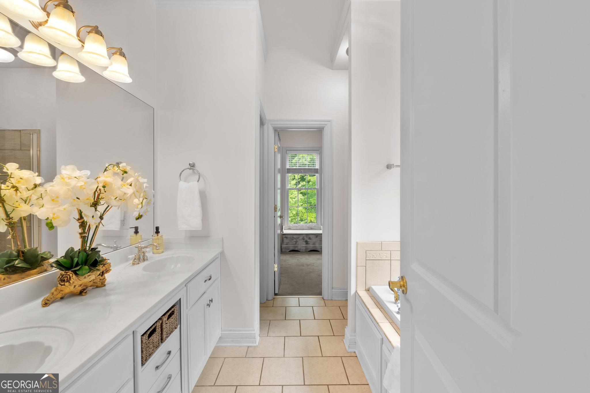 155 Rocky Way Williamson, GA 30292 - Photo 12 of 47 a spacious bathroom with a double vanity sink and a mirror