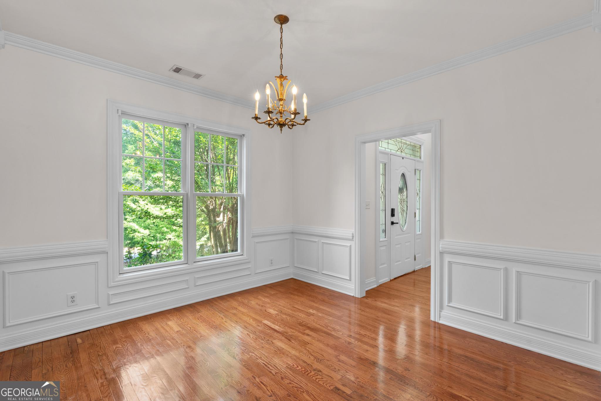 155 Rocky Way Williamson, GA 30292 - Photo 21 of 47 an empty room with wooden floor chandelier and windows