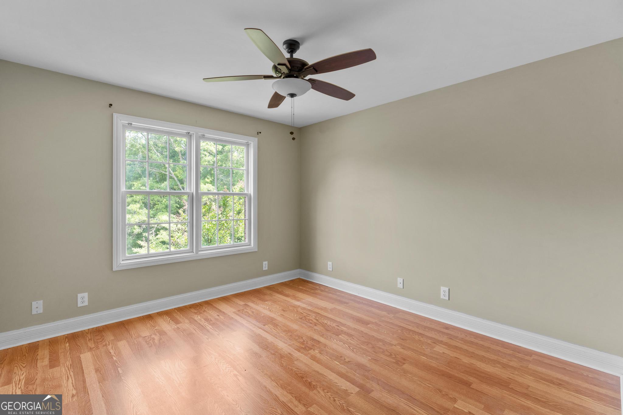 155 Rocky Way Williamson, GA 30292 - Photo 25 of 47 an empty room with wooden floor fan and windows