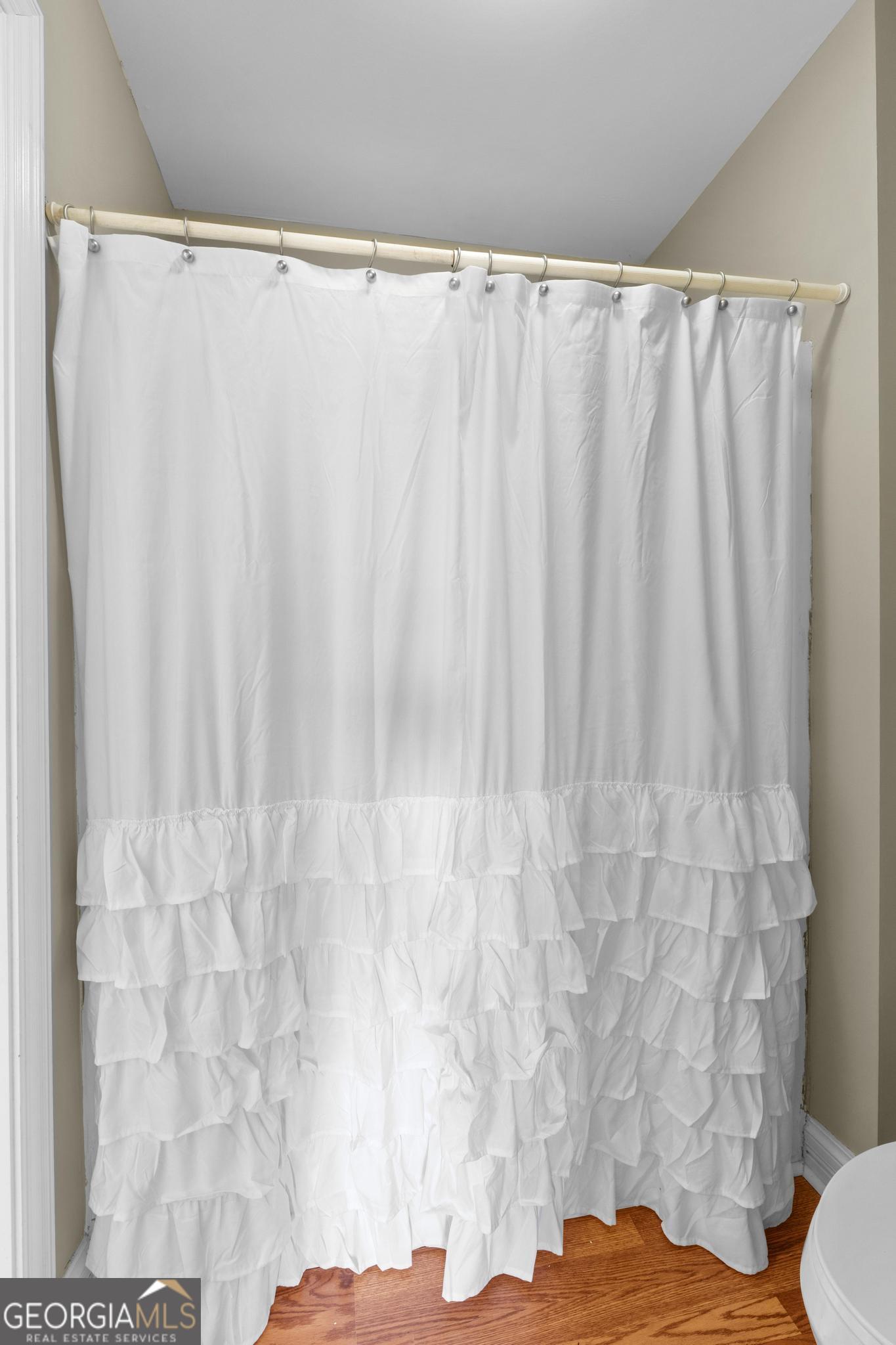 155 Rocky Way Williamson, GA 30292 - Photo 29 of 47 a bathroom with a shower curtain and a toilet
