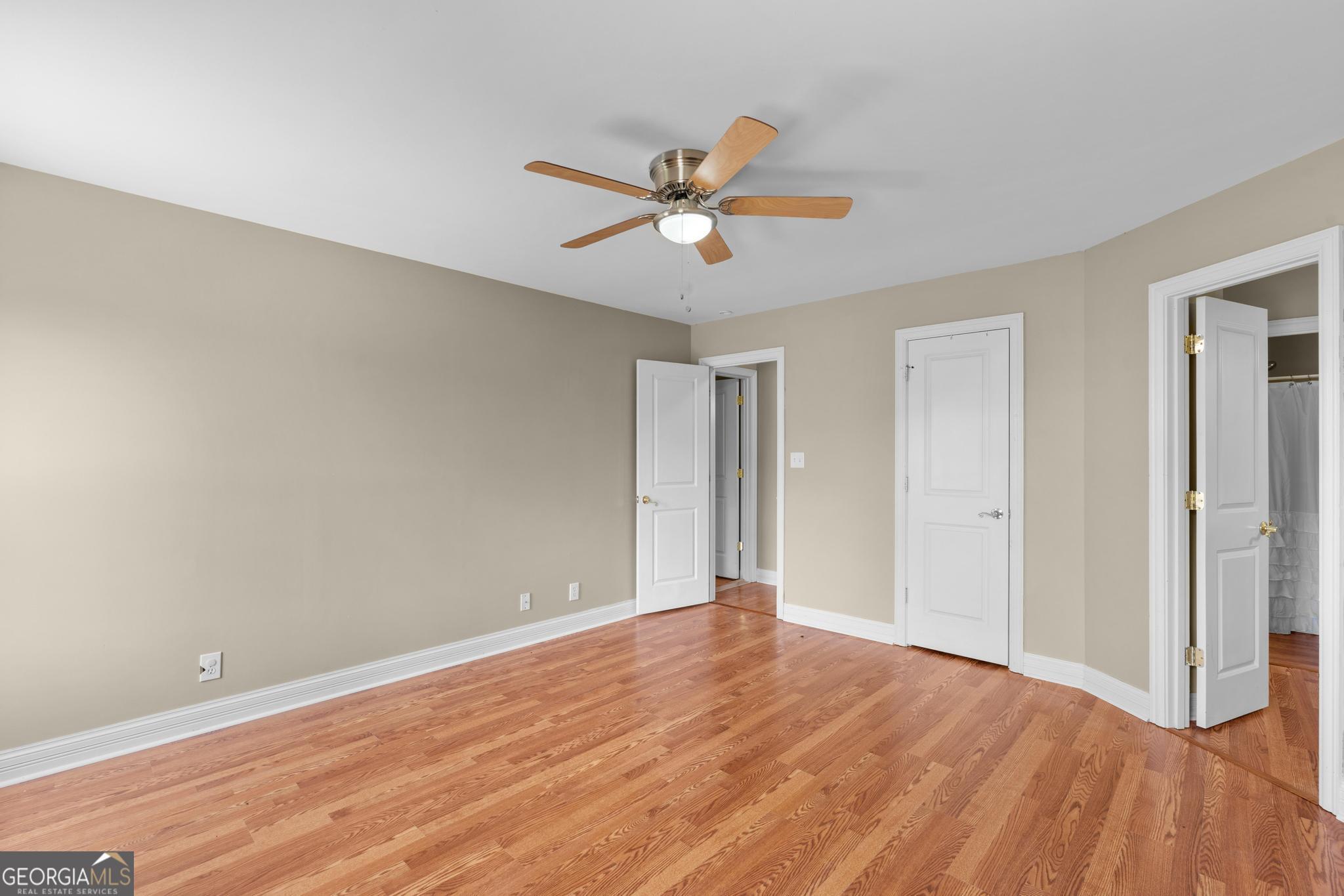 155 Rocky Way Williamson, GA 30292 - Photo 31 of 47 an empty room with wooden floor a ceiling fan and closet