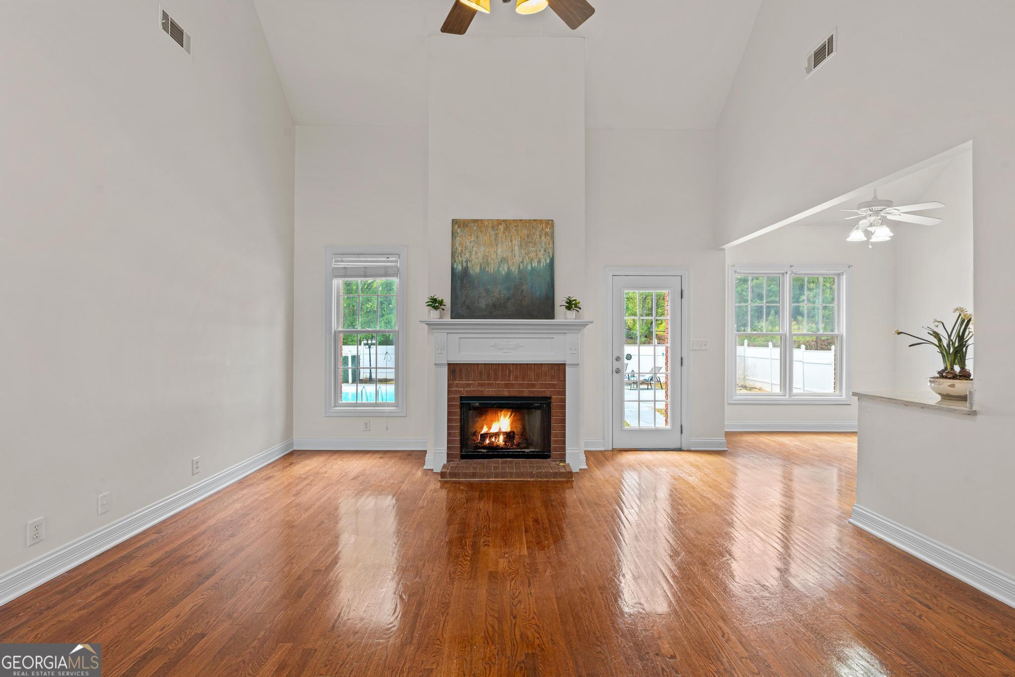 155 Rocky Way Williamson, GA 30292 - Photo 4 of 47 a living room with a fireplace and wooden floor