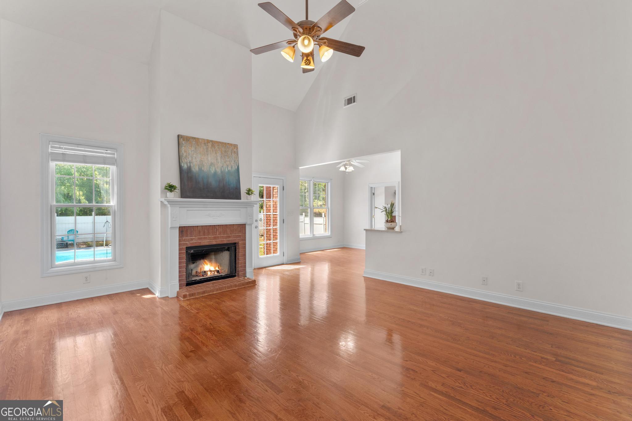 155 Rocky Way Williamson, GA 30292 - Photo 5 of 47 a view of empty room with fireplace and wooden floor