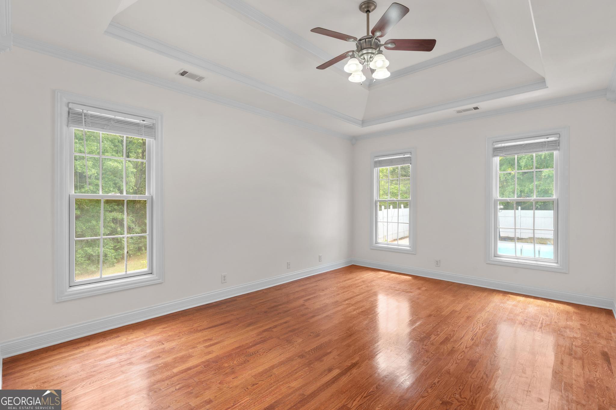 155 Rocky Way Williamson, GA 30292 - Photo 10 of 47 a view of empty room with wooden floor and fan