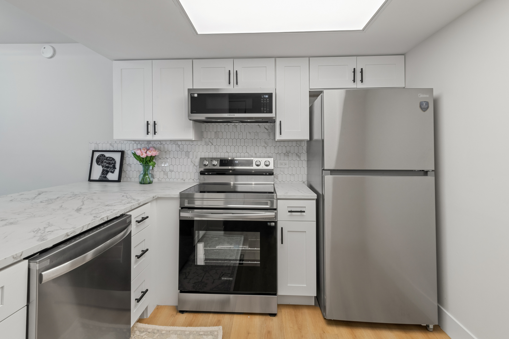 830 Elder Road, Unit B104 Homewood, IL 60430 - Photo 5 of 19 a kitchen with stainless steel appliances granite countertop a refrigerator a stove a microwave and cabinets