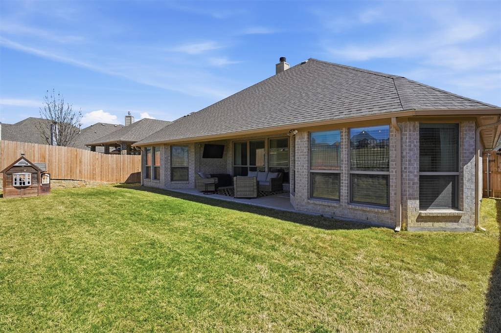 7224 Prestwick Terrace Benbrook, TX 76126 - Photo 23 of 26 Rare golf course lot featuring elegant wrought iron fencing that showcases expansive greenway views. This private backyard oasis offers a perfect vantage point for serene sunsets and rolling fairways, all from the comfort of your covered patio
