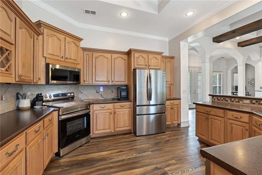 166 Freedom Lane Commerce, GA 30530 - Photo 15 of 25 a kitchen with stainless steel appliances granite countertop a refrigerator stove top oven and sink