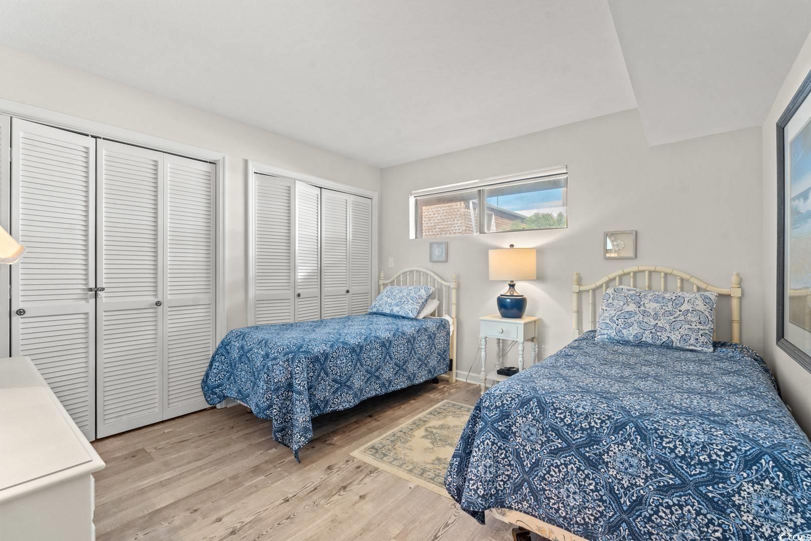 5507 North Ocean Boulevard, Unit 113 Myrtle Beach, SC 29577 - Photo 12 of 28 Bedroom with multiple closets and light wood-style flooring